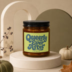 Amber jar candle with black lid and "Queerly Ever After" Vowed label.