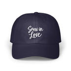 Dark blue baseball cap embroidered with the white script text "Snow in Love" on the front.