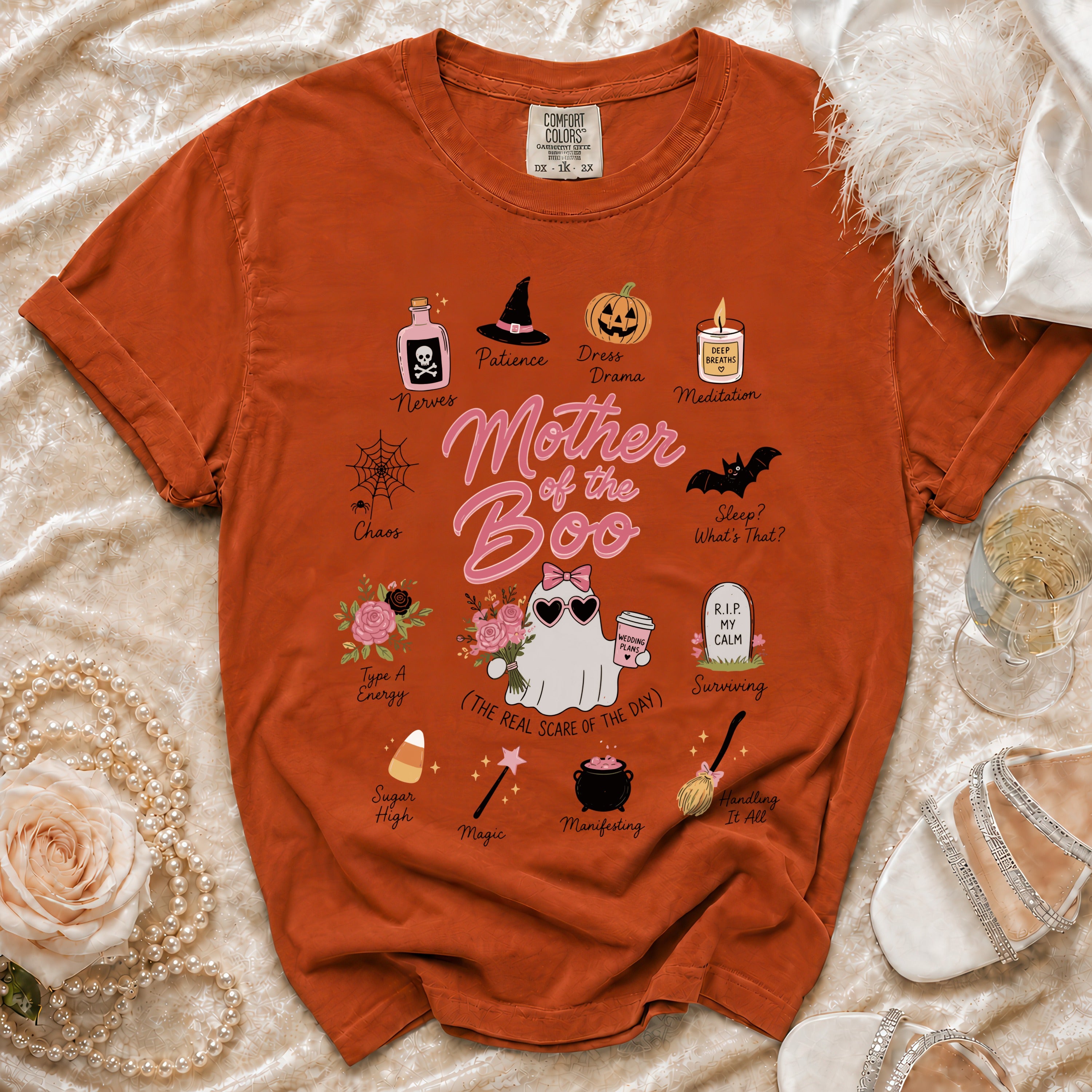 Orange t-shirt with "Mother of the Boo" Halloween graphic and assorted icons.