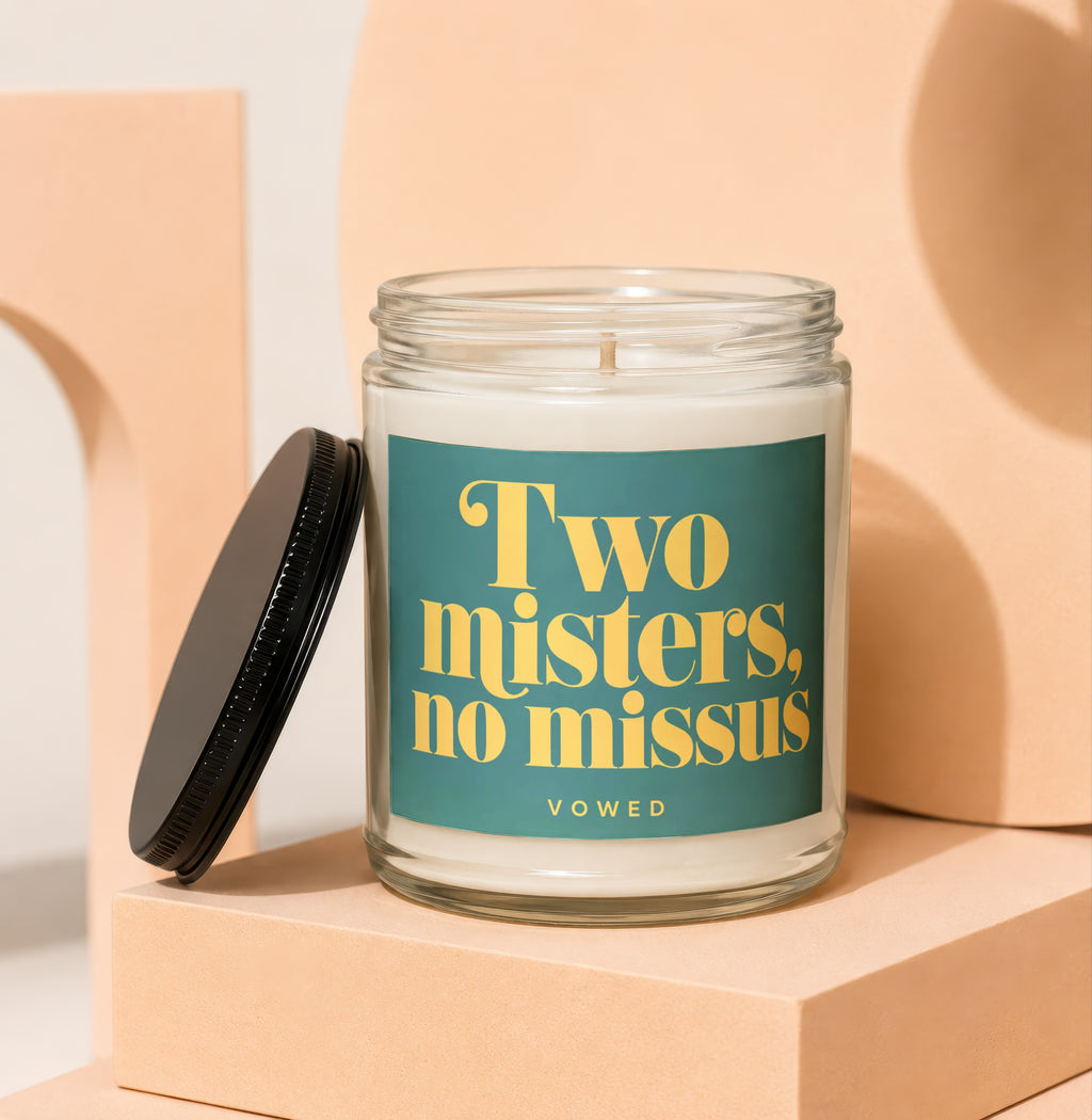 Glass candle with green label reading "Two misters, no missus" and "VOWED".