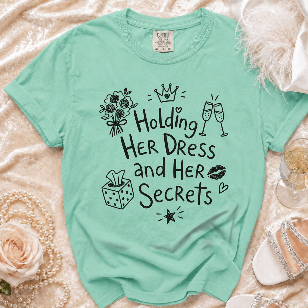 Mint green t-shirt with black graphic text "Holding HER DRESS and HER Secrets".
