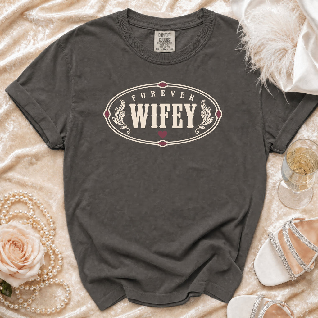 Dark grey t-shirt with "FOREVER WIFEY" oval graphic and decorative elements.