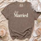 Brown t-shirt with "Just Married" text, laid flat with pearls and shoes.
