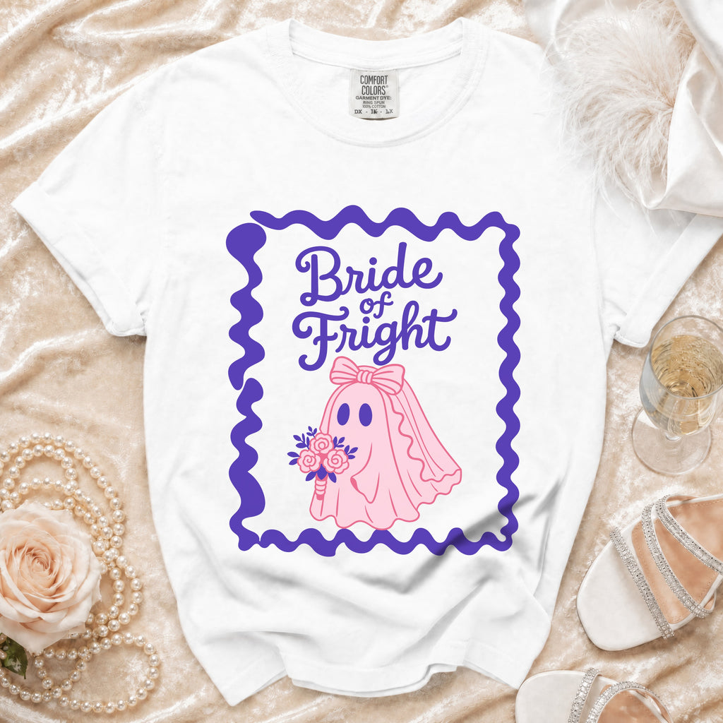 White t-shirt with "Bride of Fright" text and a pink ghost bride graphic.