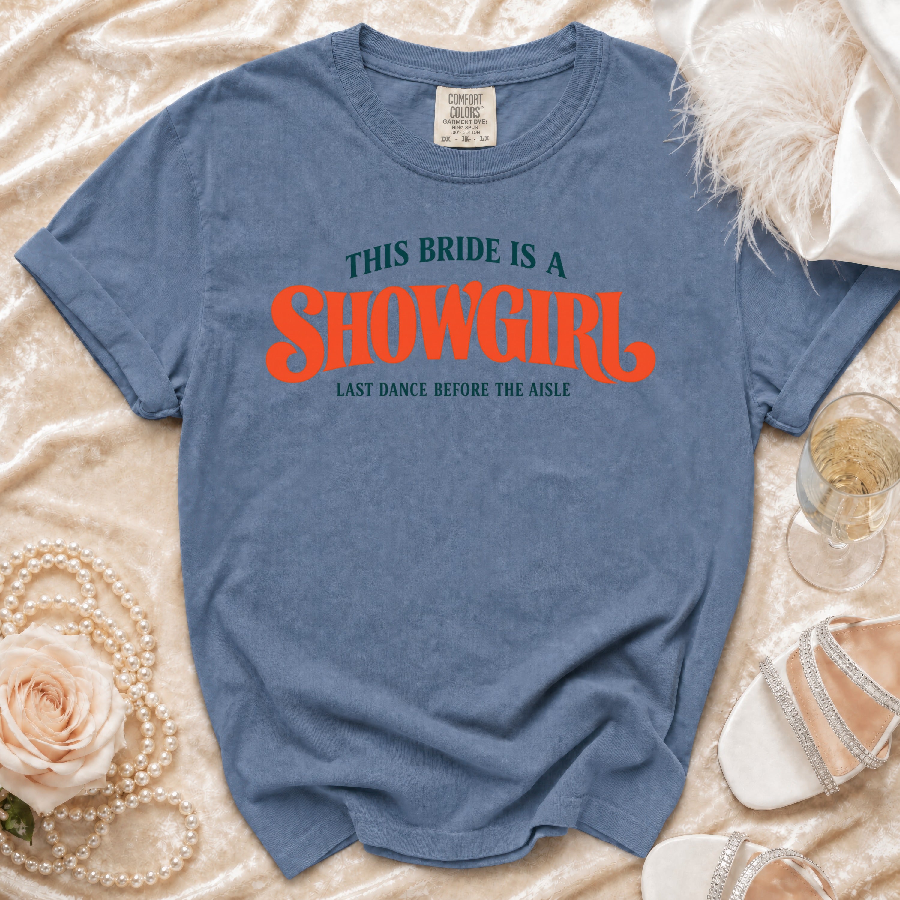 Blue t-shirt with "This bride is a showgirl last dance before the aisle" text.