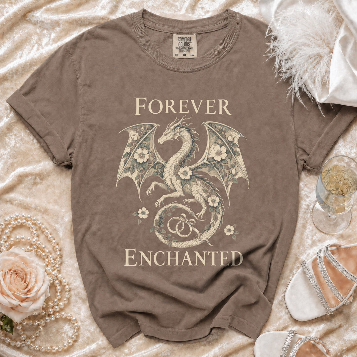 T-shirt with dragon design, text "FOREVER ENCHANTED," and wedding rings.