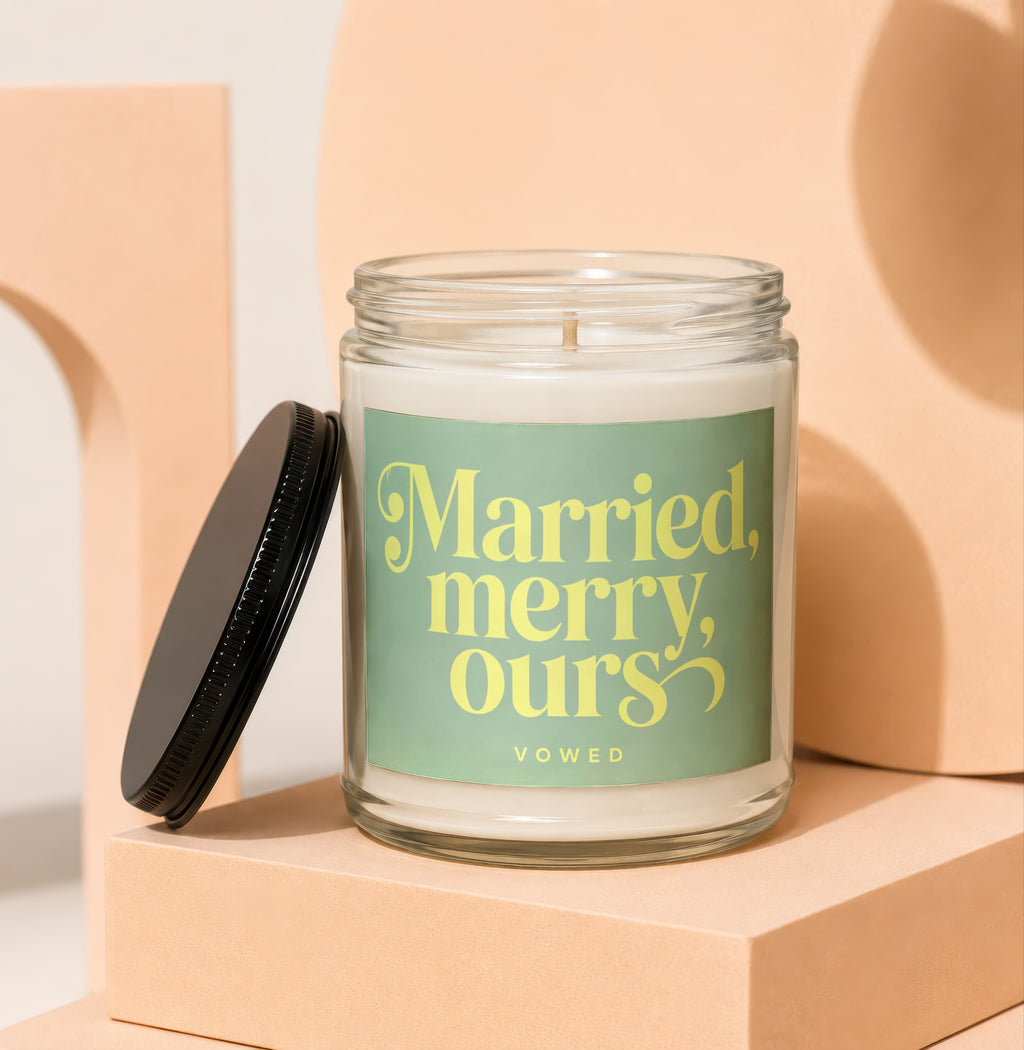 Glass candle with green label saying "Married, merry, Ours" and "VOWED".