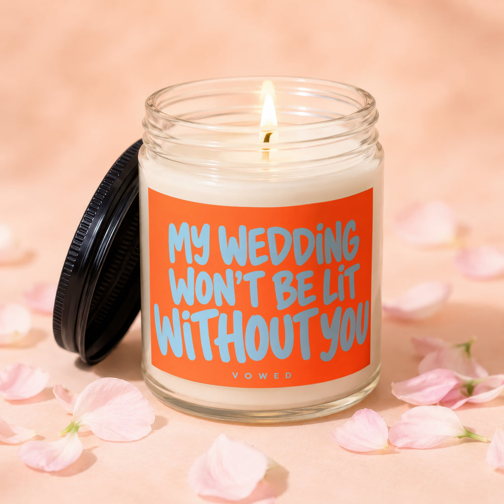 Candle with lit wick and label reading "MY WEDDING WON'T BE LIT WITHOUT YOU".