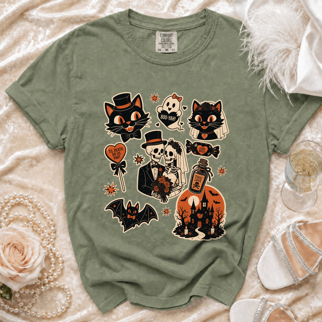 Green t-shirt with Halloween graphic featuring cats, skeletons, ghost, and haunted house.
