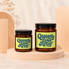 Two glass jars with black lids and lime green labels reading "Queerly Ever After."