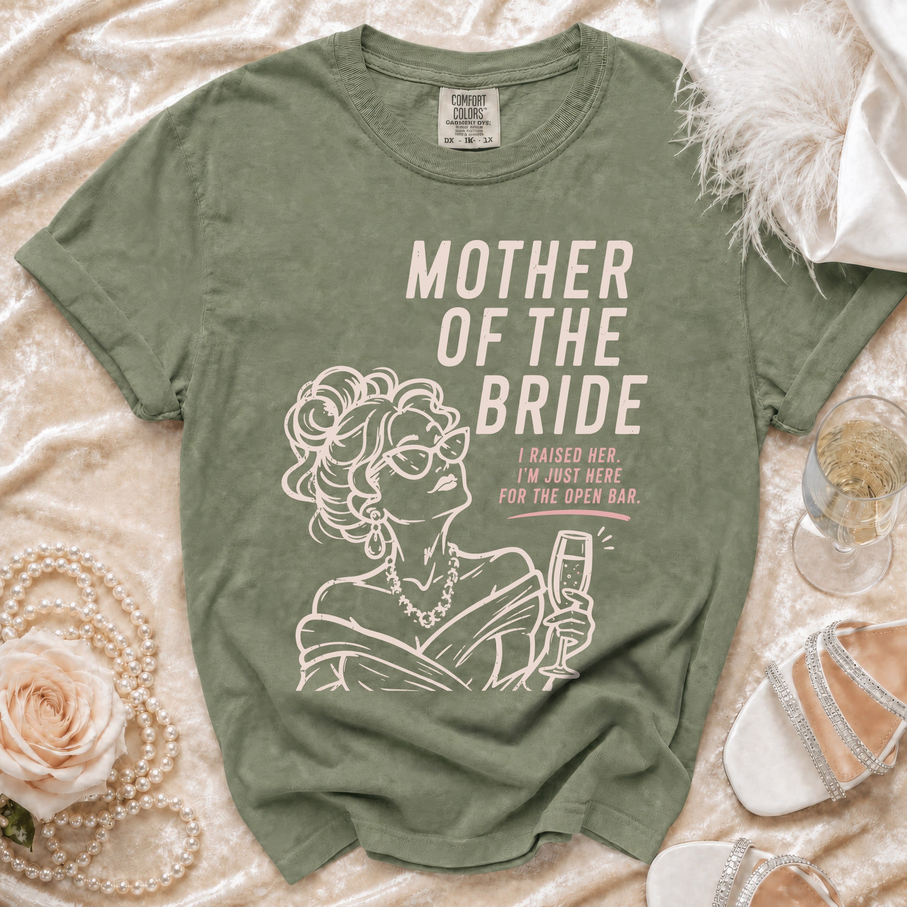 Green t-shirt with "Mother of the Bride" text and a woman holding champagne, I Raised Her. I'm Just Here For The Open Bar.