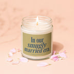 Lit candle in jar with label reading "In our smugly married era."