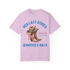 Pink t-shirt with "Her Last Rodeo" text, cowboy boots, and bow.