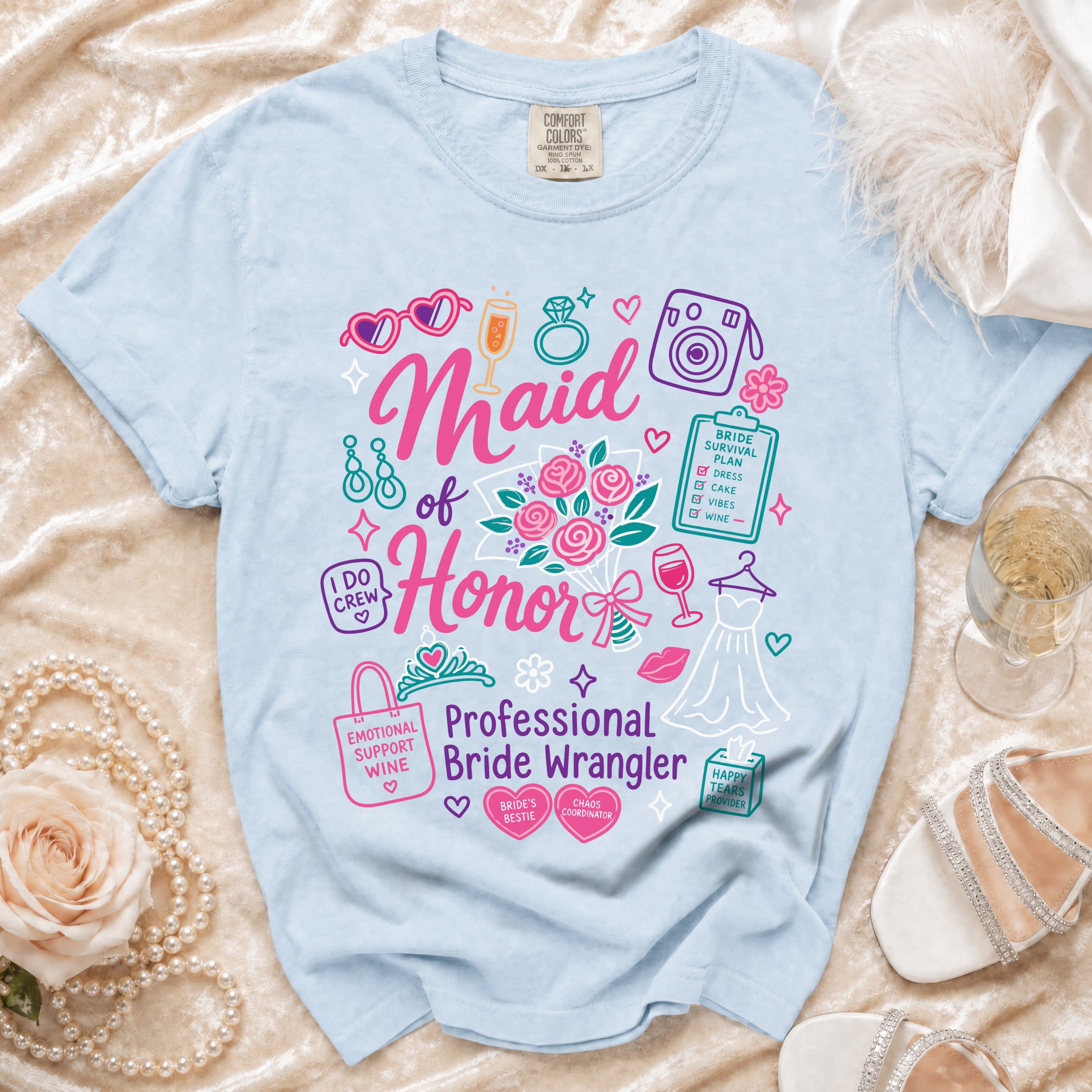 Light blue t-shirt with "Maid of Honor Professional Bride Wrangler" graphics and wedding icons.