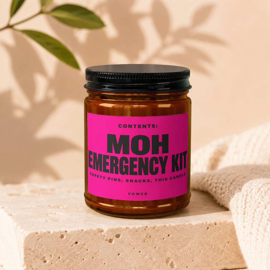 Amber jar with black lid labeled "MOH Emergency Kit" including "Safety Pins, Snacks, This Candle".