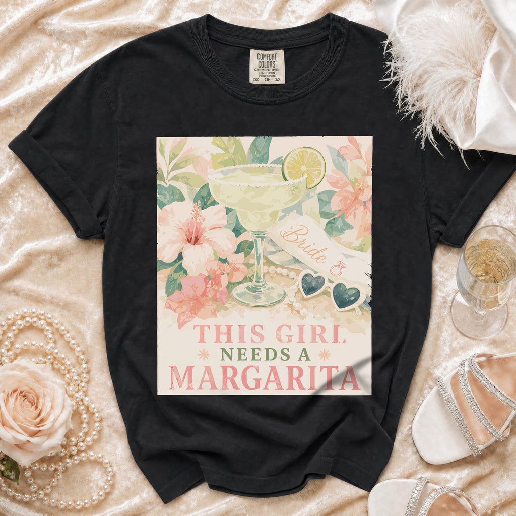 Black Comfort Colors shirt with a graphic of a margarita and the text "This Girl Needs a Margarita".