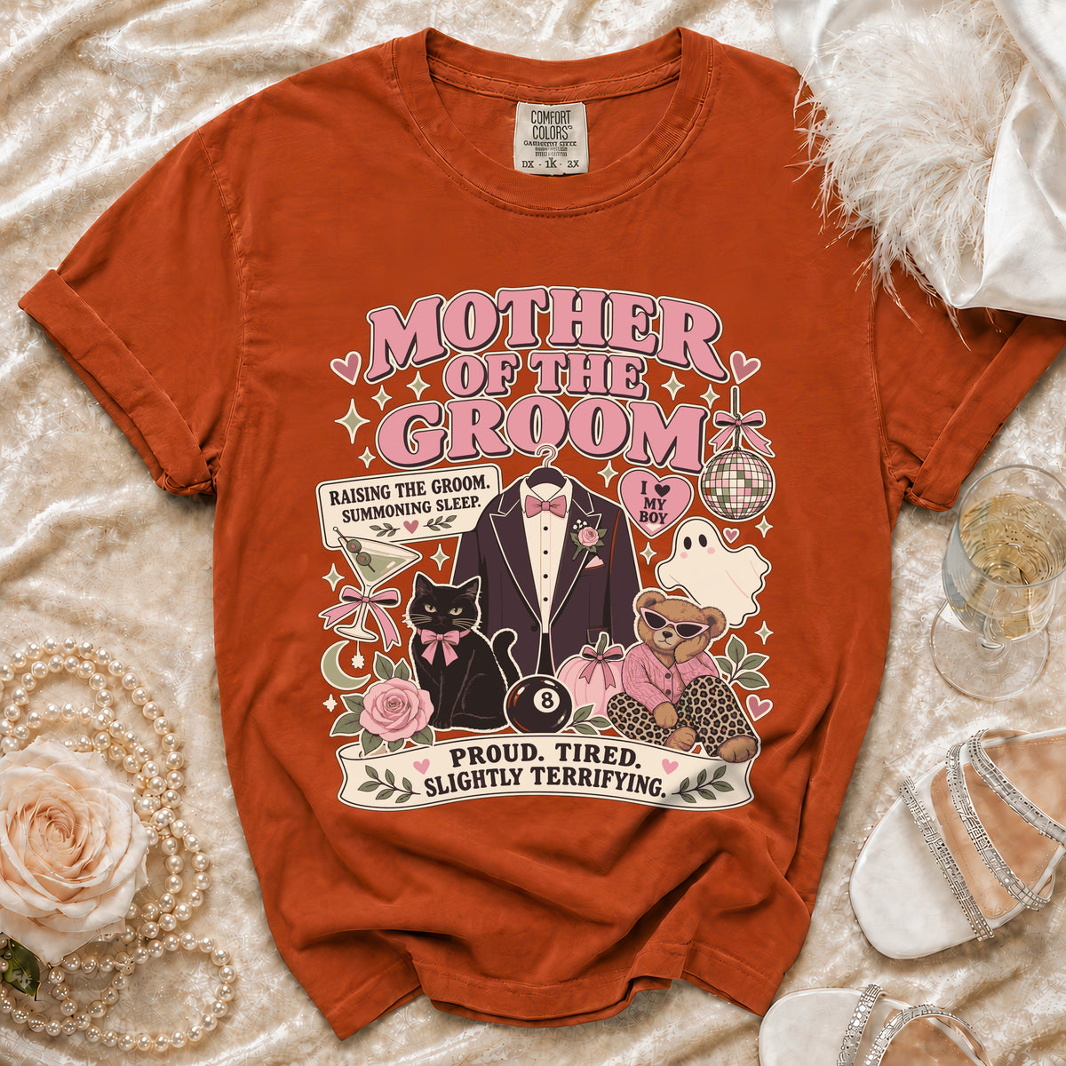 "Mother of the Groom" graphic tee with icons of a tuxedo, cat, bear, ghost, and text.