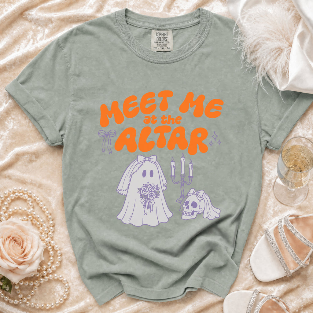 T-shirt with orange text "MEET ME at the ALTAR" and ghostly wedding graphics.