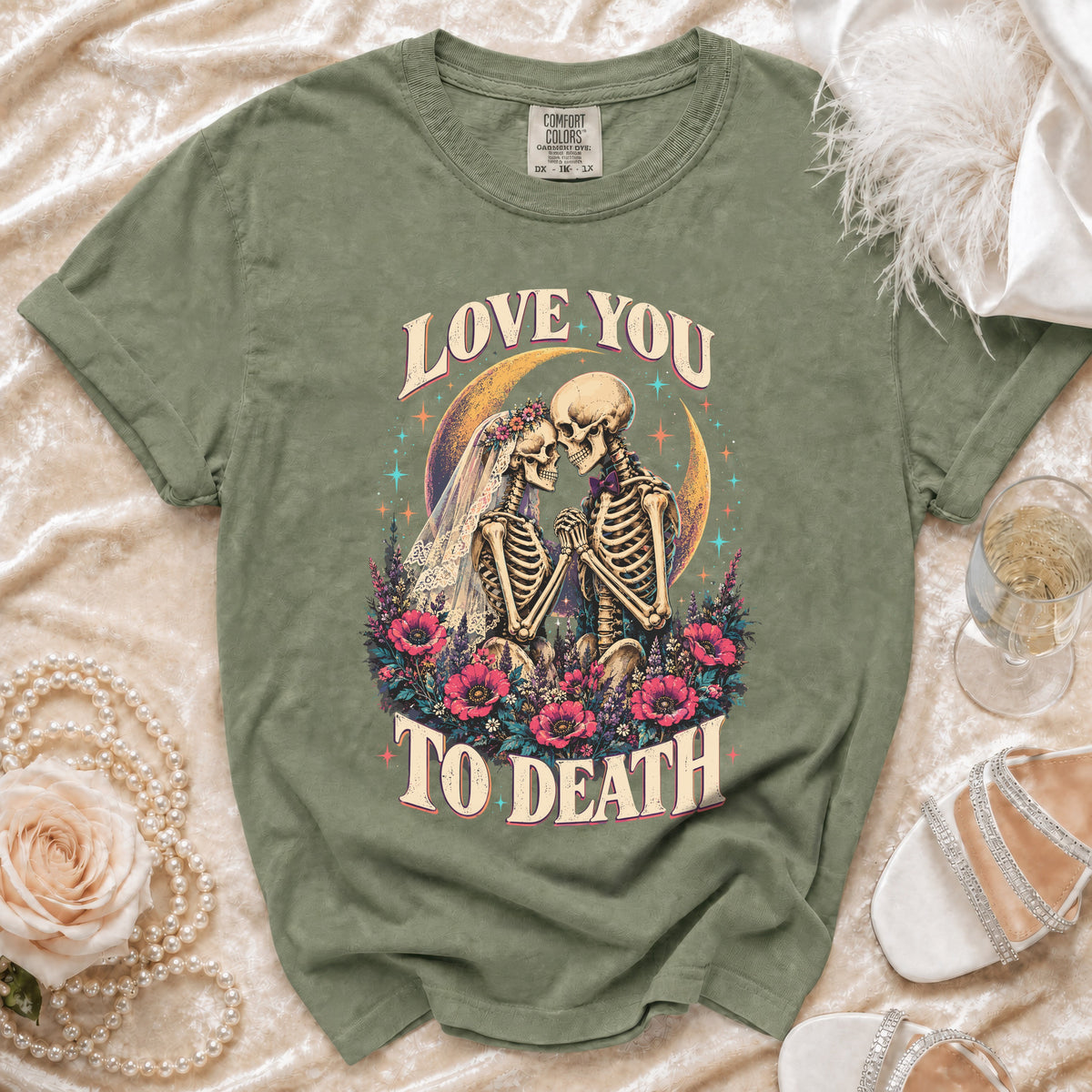 Green t-shirt with "Love You To Death" skeleton wedding graphic.