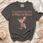Dark grey t-shirt with "This Mother of the Bride is Here for Booze" text and graphic.