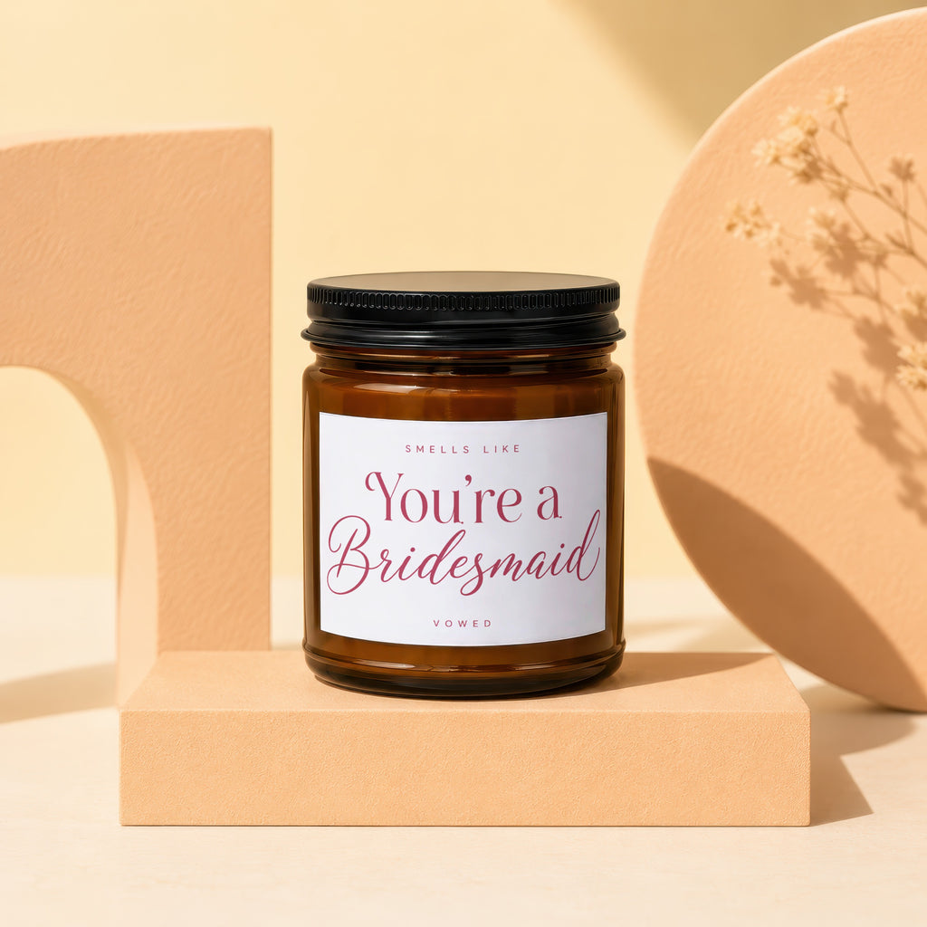 Amber glass candle labeled "Smells Like You're a Bridesmaid" by Vowed.