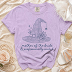 Purple t-shirt with witch hat graphic and text "mother of the bride & professionally wicked".