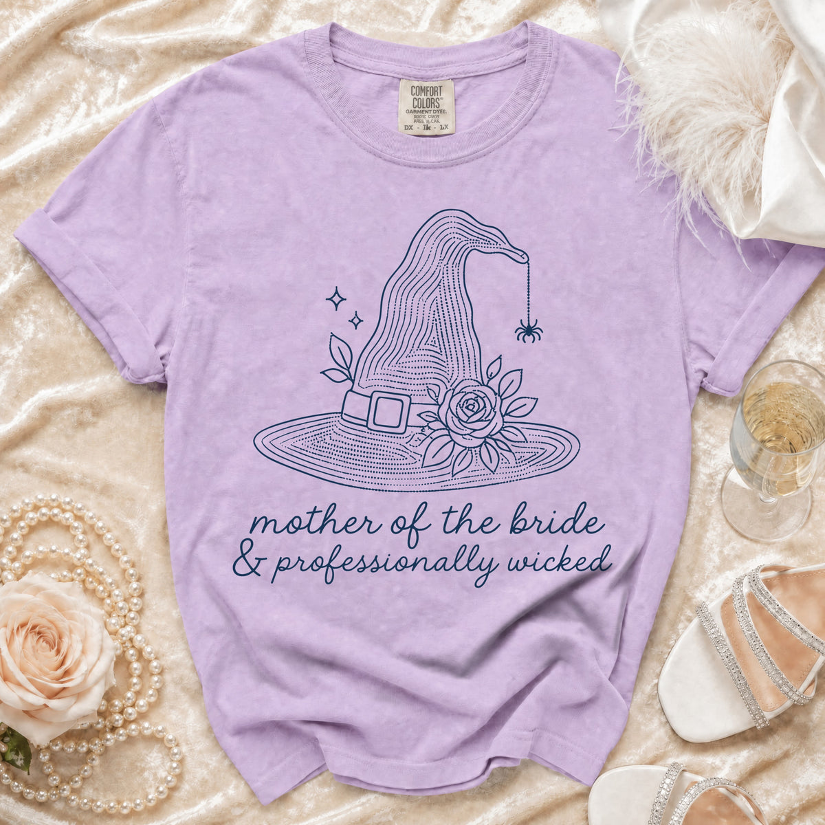 Purple t-shirt with witch hat graphic and text "mother of the bride & professionally wicked".