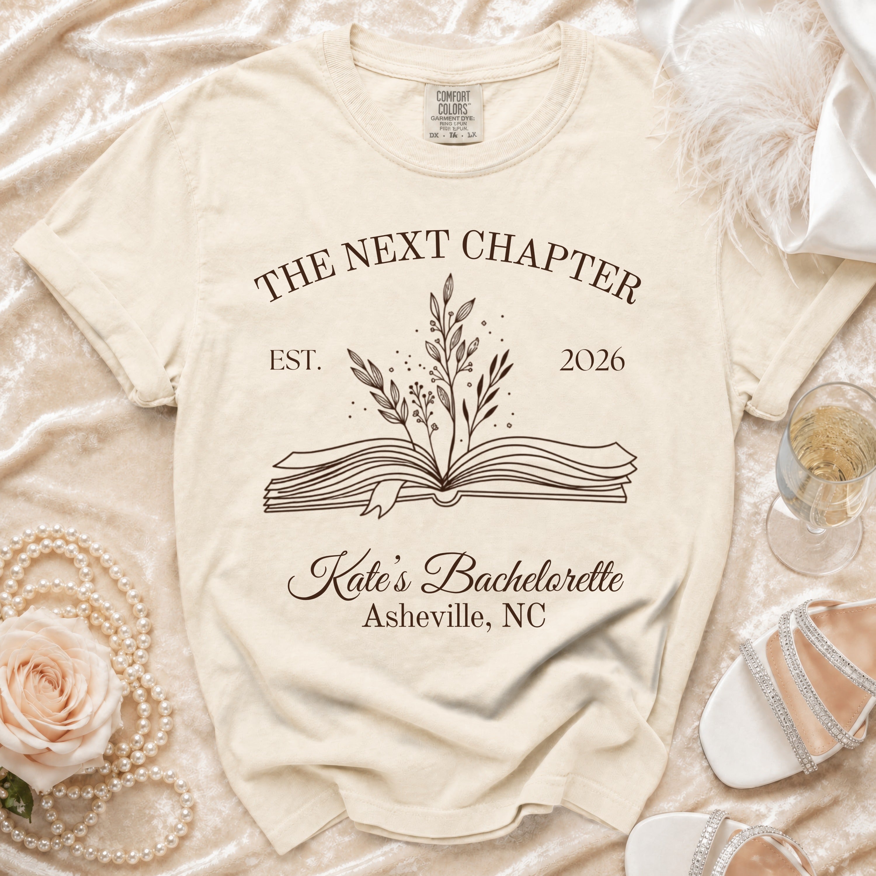 Cream t-shirt with "The Next Chapter" graphic, "Kate's Bachelorette Asheville, NC".