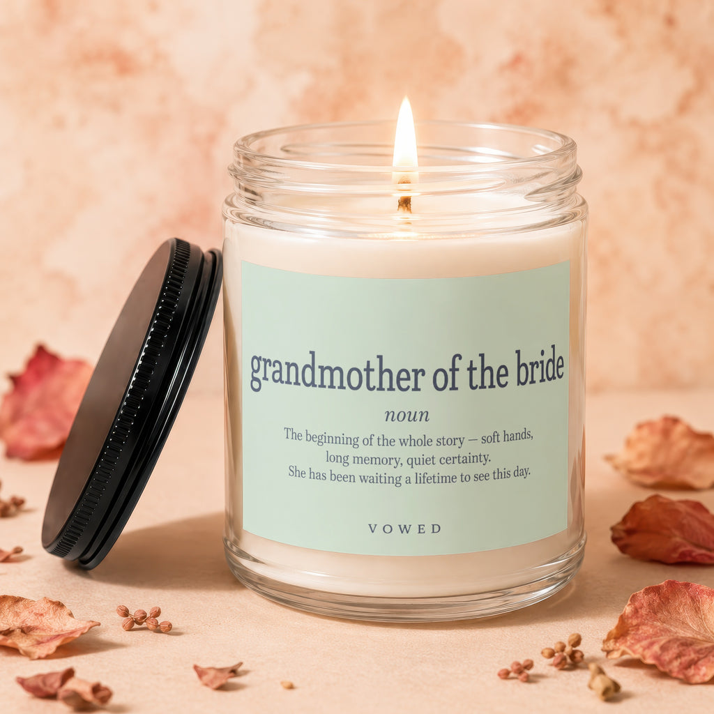 Glass candle labeled "grandmother of the bride" with lit wick.