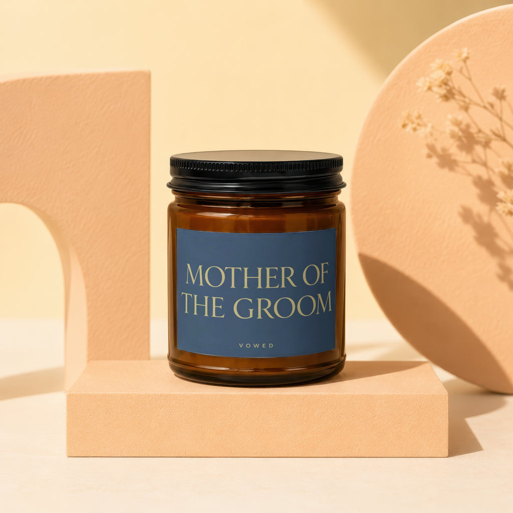 Amber glass candle with "MOTHER OF THE GROOM" text on a blue label.