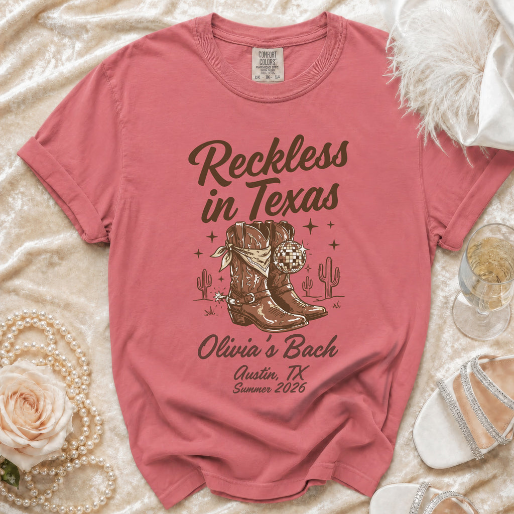 T-shirt with cowboy boots, disco ball, and "Reckless in Texas" text.