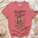 T-shirt with cowboy boots, disco ball, and "Reckless in Texas" text.