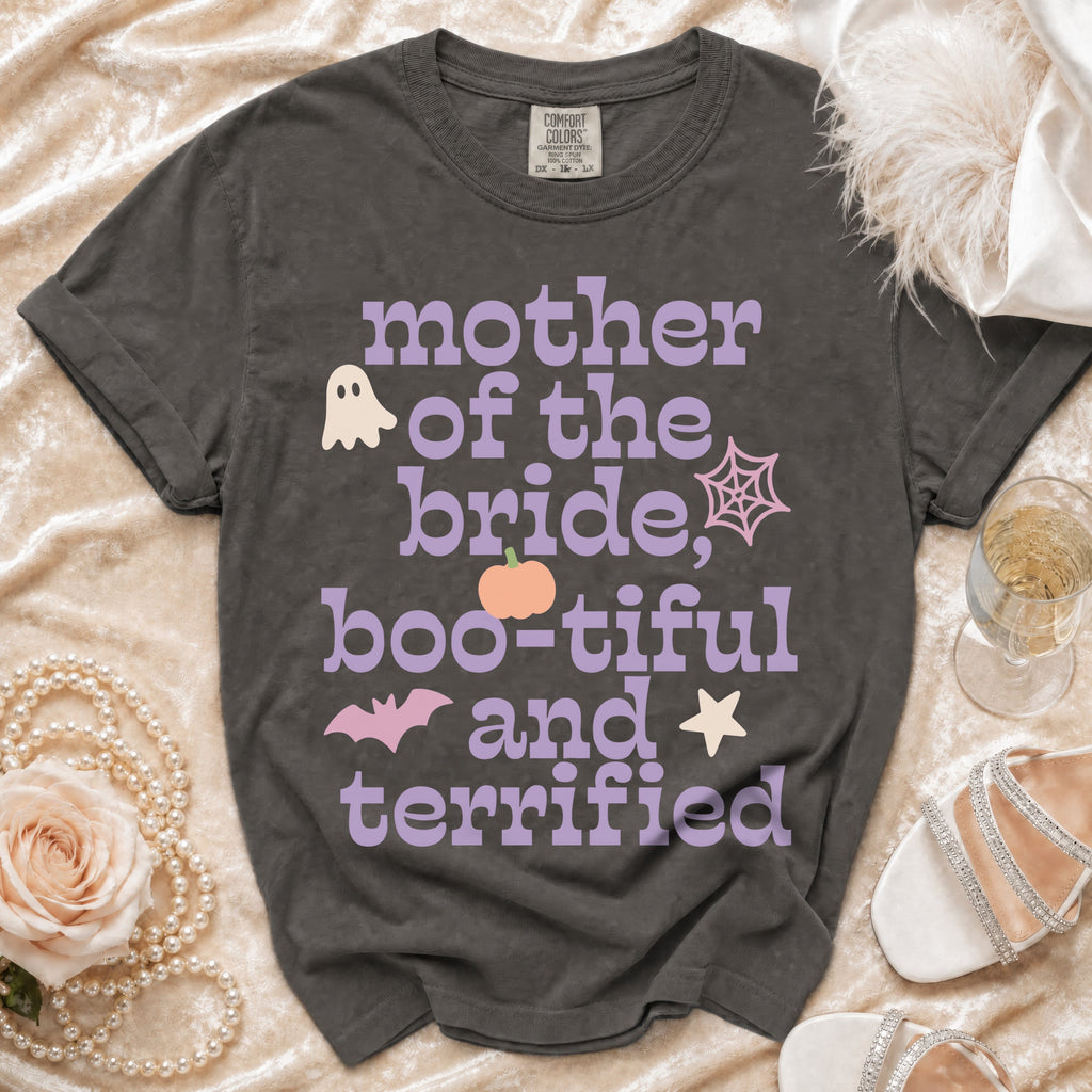 Dark gray t-shirt with purple and pink text reading Mother of the Bride, Boo-tiful and Terrified surrounded by Halloween icons.