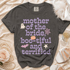 Dark gray t-shirt with purple and pink text reading Mother of the Bride, Boo-tiful and Terrified surrounded by Halloween icons.