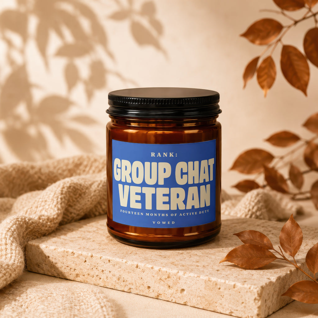 Amber jar candle labeled "Group Chat Veteran" with "Rank:", "Fourteen Months of Active Duty", and "Vowed".