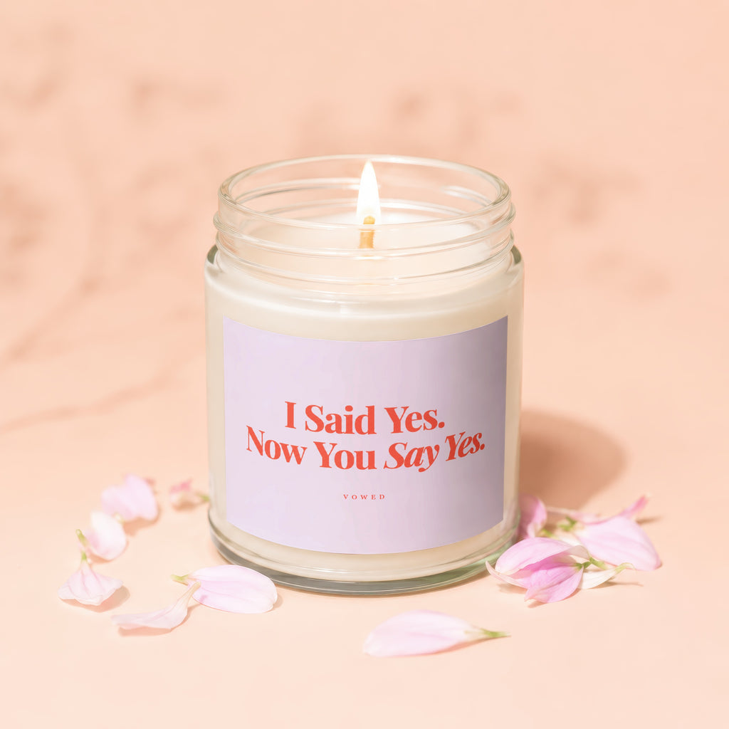 Candle with "I Said Yes. Now You Say Yes." text and pink petals.