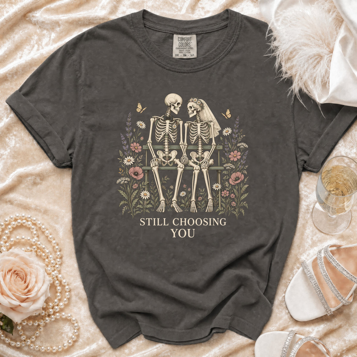 Dark grey t-shirt with skeleton couple illustration and text "STILL CHOOSING YOU".