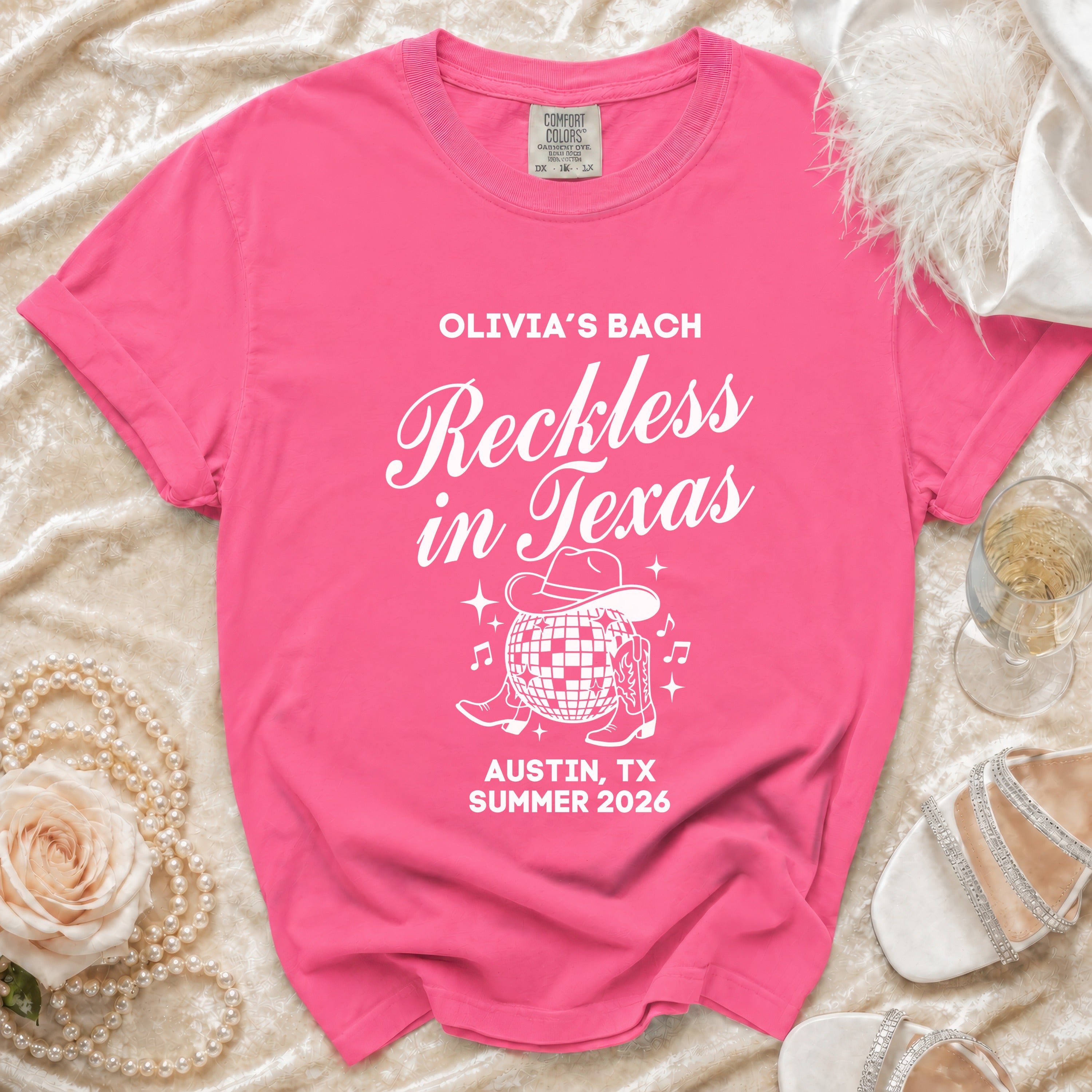 Pink t-shirt for Olivia's Bach in Texas, featuring cowboy boot and disco ball.
