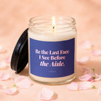 Candle with lit wick, black lid, and label reading "Be the Last Face I See Before the Aisle. VOWED."