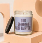 Glass candle with black lid removed, label reads "Our Ordinary Dark Fairytale".