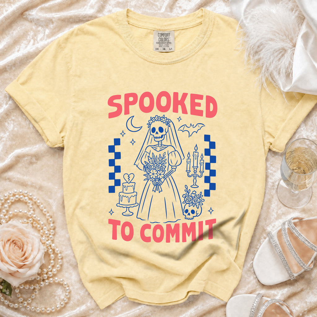 Yellow t-shirt with "SPOOKED TO COMMIT" text and skeleton bride graphic.
