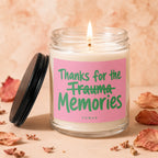 Candle with pink label reading "Thanks for the Trauma Memories"