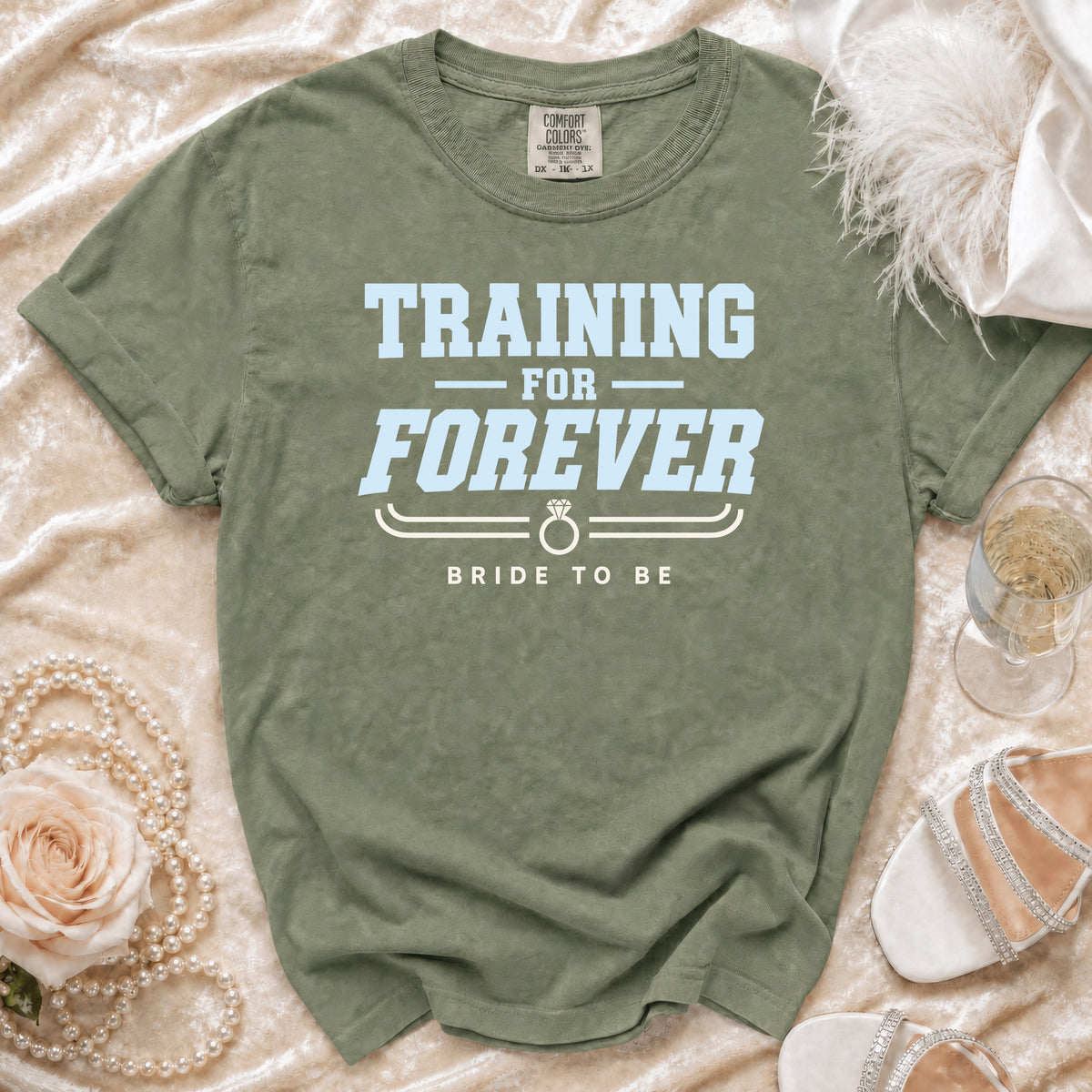 Olive green t-shirt with "TRAINING FOR FOREVER BRIDE TO BE" text.