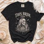 Black t-shirt with "This Bride Bites" text and skeleton bride graphic.