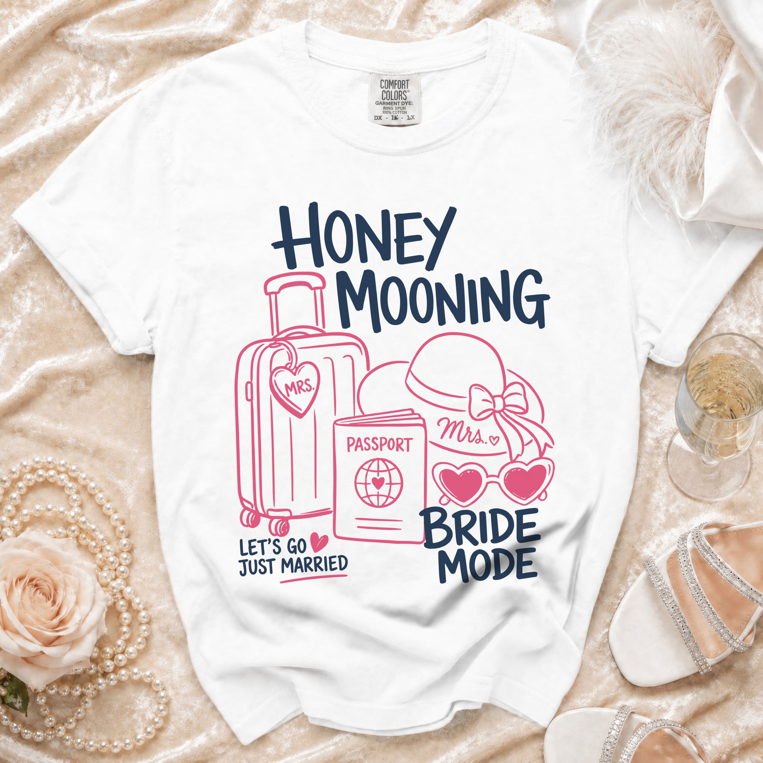 White t-shirt with "Honey Mooning Bride Mode" text and travel icons.