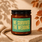 Amber jar candle with green label that reads "Status: We survived the wedding."