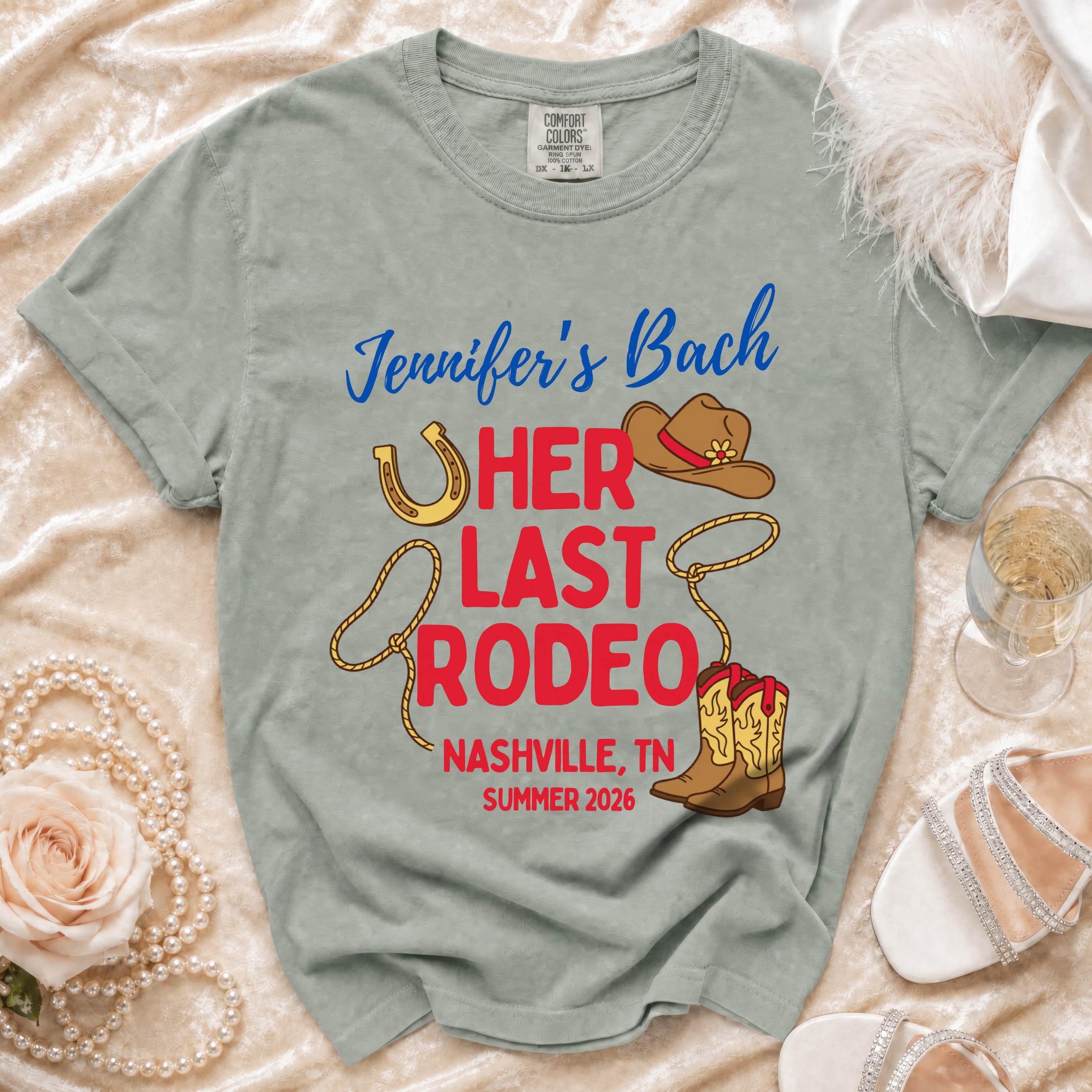 "Jennifer's Bach" and "Her Last Rodeo" text on a grey t-shirt with cowboy boots and hat.