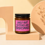 Amber candle with black lid and pink label reading "Only Hot B*tches Are Bridesmaids".