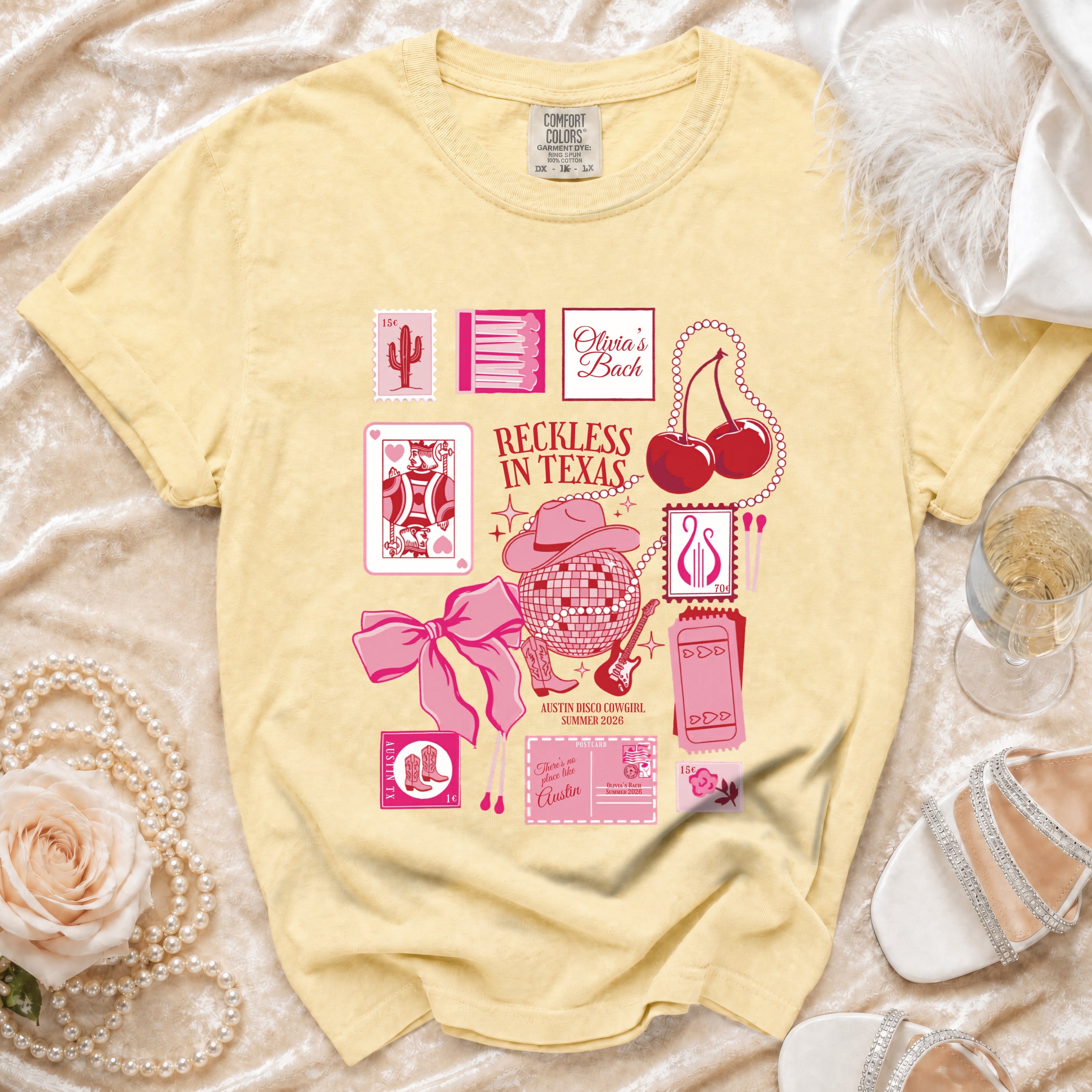 Yellow t-shirt with "Olivia's Bach" and "Reckless in Texas" graphic.