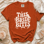Orange t-shirt with "This Bride Bites" graphic featuring vampire fangs.